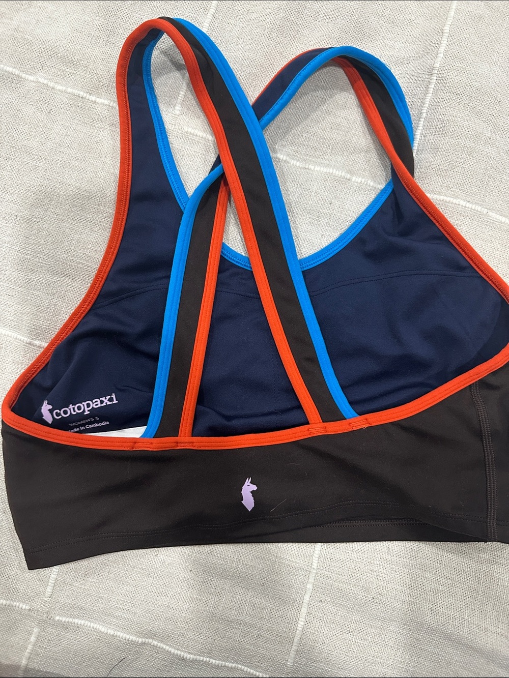 Cotopaxi Women’s Navy & Black Strappy Sports Bra with Orange Trim